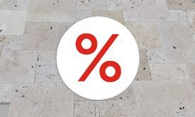 Platten und Rasenstück, darüber ein Sale-Zeichen