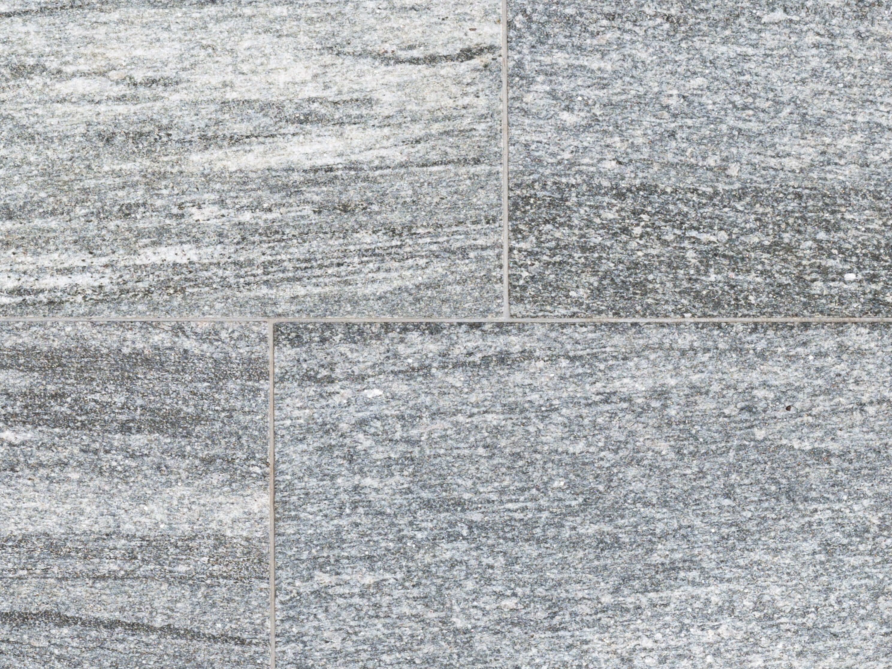 Musterungen von dunklen Grautönen bis Weiß. Nahaufnahme von grauen Granitplatten Urban Grey Line