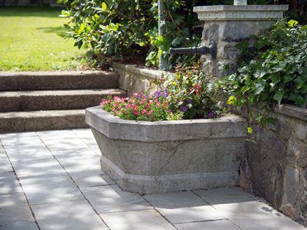 Sandsteinplatte in Grau Kandla Grey Brunnen mit Blumen