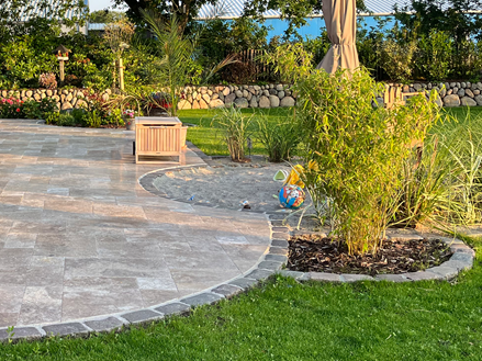 Travertin Noce Terrasse mit Sandkasten Runde Terrasse Abendstimmung