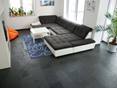 Wohzimmer mit schwarz-weißer Couch und Schieferfliese Mustang als Bodenbelag